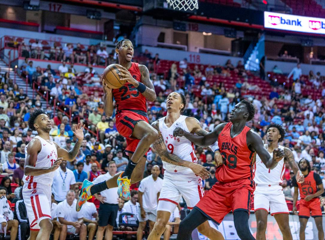 Chicago Bulls guard Dalen Terry (25) elevates for a basket over Toronto Raptors forward D.J. Wi ...