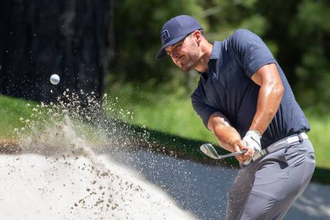 Derek Carr chips out of a sand trap on the 17th hole during the first round of the American Cen ...