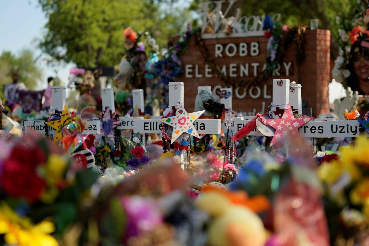 A makeshift memorial honoring those recently killed is formed around Robb Elementary School, Su ...