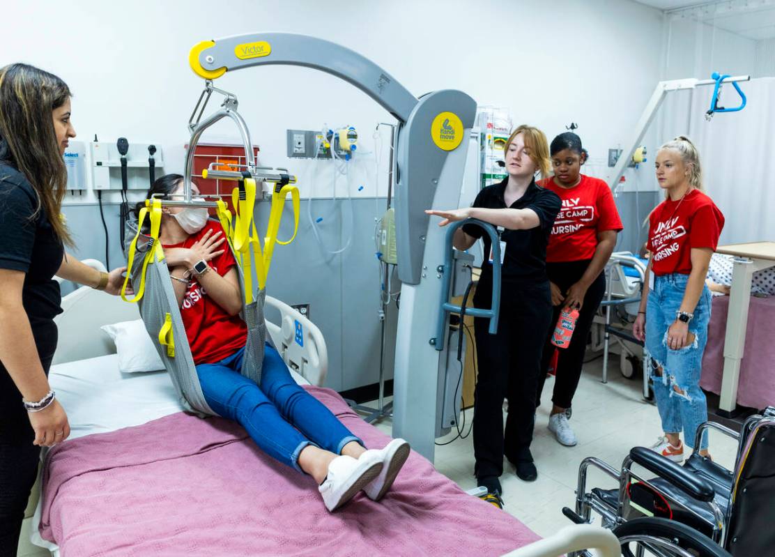 (From left) UNLV nursing student Reet Pabla ensures that participant Rockelle Aguilar is secure ...