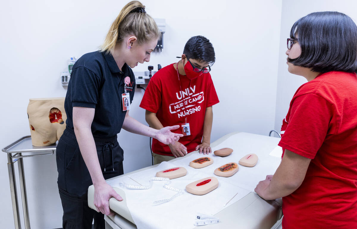 (From left) UNLV nursing student Kennedy Russum talks about wound care with participants Kobe a ...