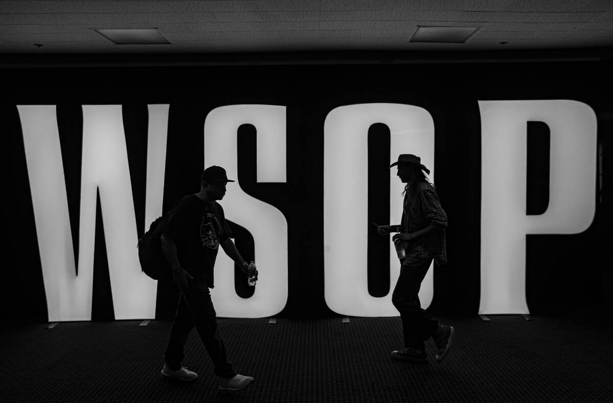 People walk by signage for the World Series of Poker at Bally’s on Tuesday, July 5, 2022 ...