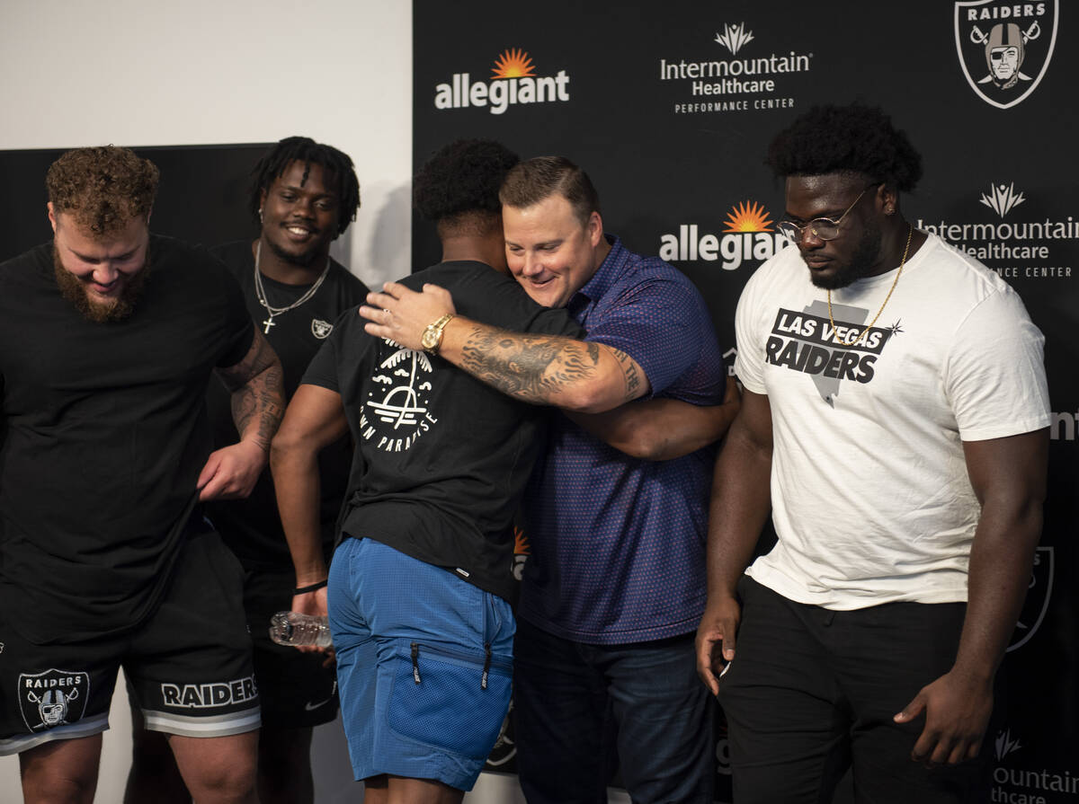 Las Vegas Raiders offensive guard Richie Incognito, center, hugs teammate Kenyan Drake after an ...