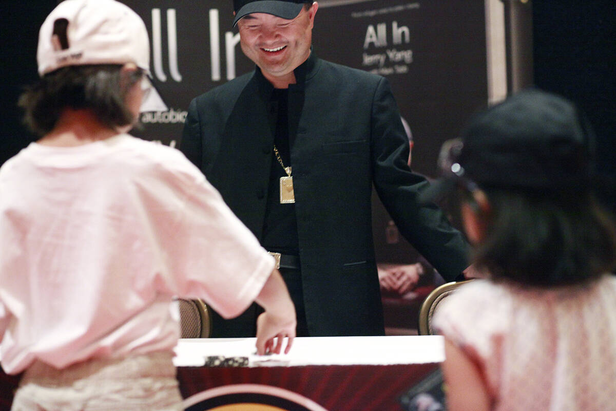 2007 World Series of Poker Main Event Champion Jerry Yang watches Alexa Fisher, 8, left, of Cib ...