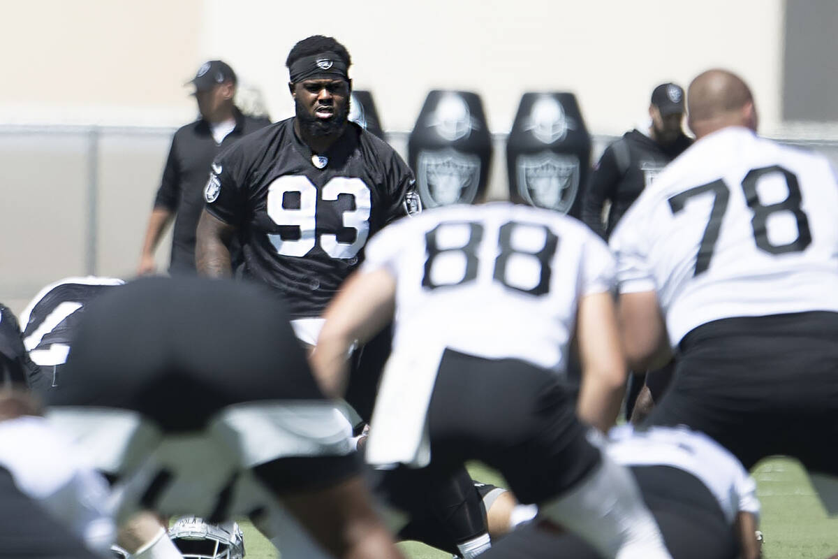 Raiders defensive tackle Neil Farrell, Jr. (93) stretches during the team’s mandatory mi ...