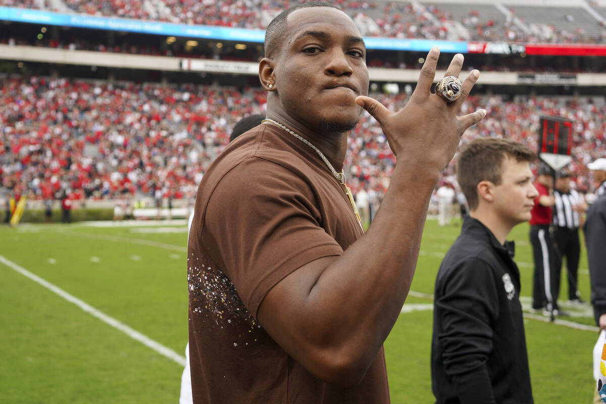 Former Georgia running back Zamir White holds up his National Championship ring in the first ha ...