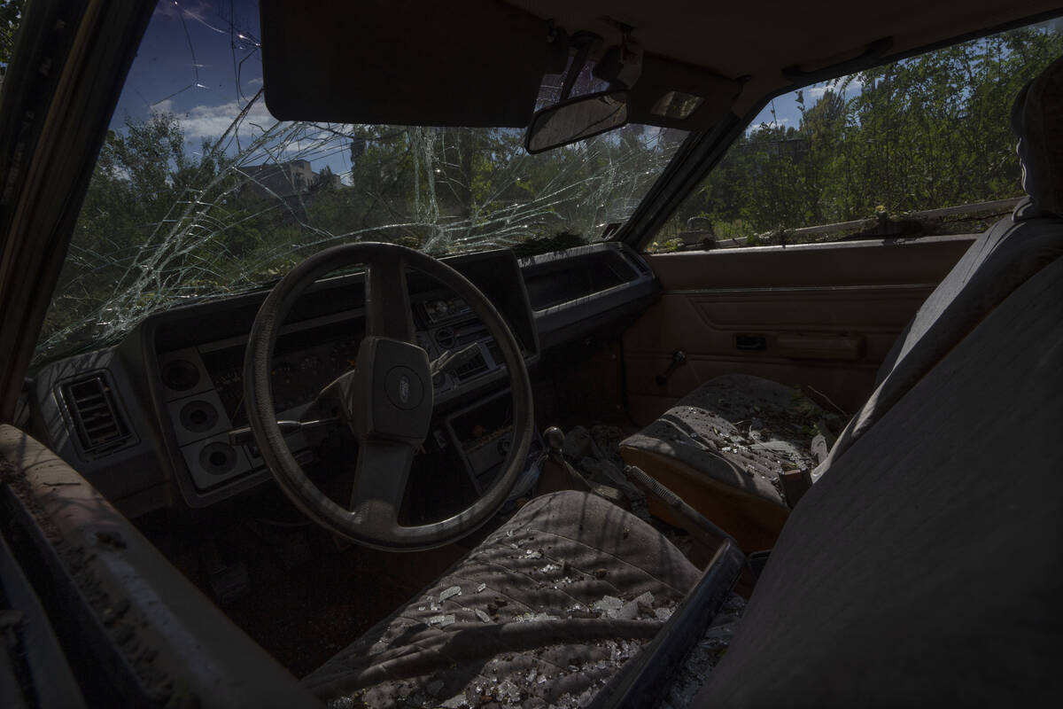 FILE - A damaged car in the aftermath of a missile strike in Konstantinovka, in Donetsk Oblast, ...