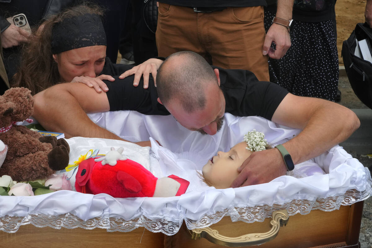 Artem Dmitriev gives the last salute to his daughter Liza, 4-year-old girl killed by Russian at ...