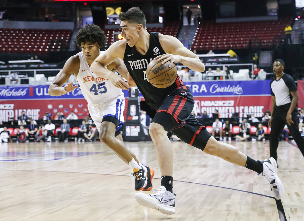 Portland Trail Blazers' Luka Garza drives to the basket against New York Knicks' Jericho Sims ( ...