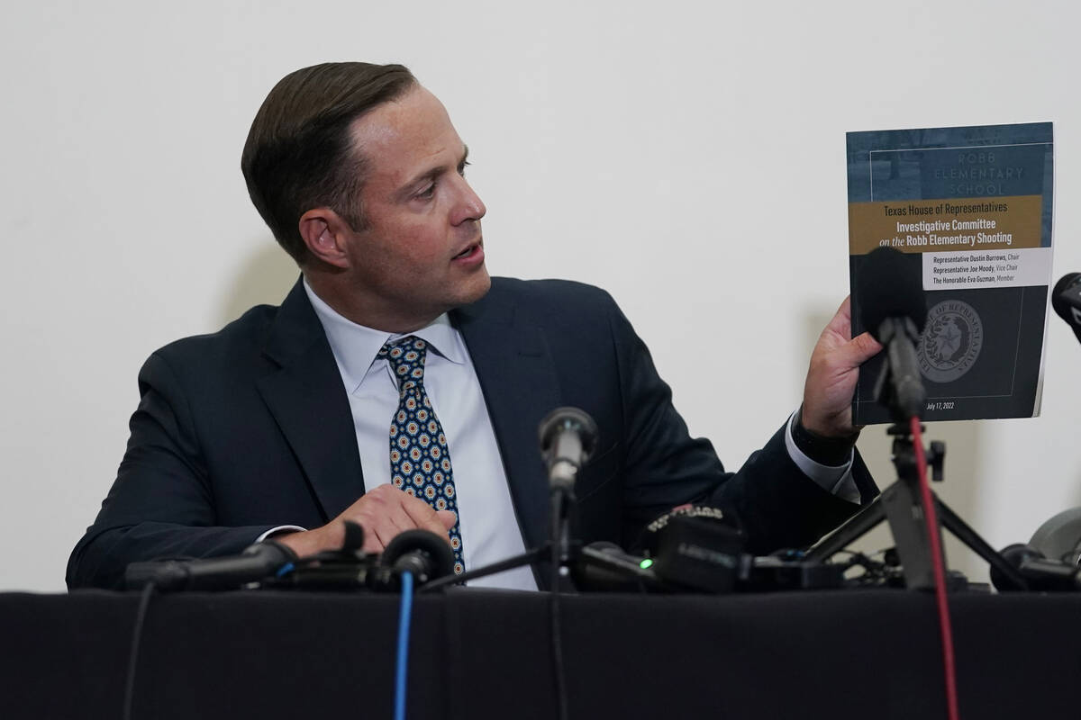 Texas House investigative committee chairman Rep. Dustin Burrows holds a copy of its full repor ...