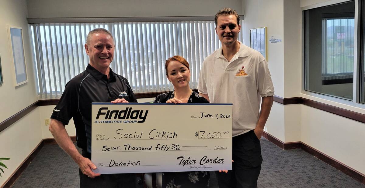 Tyler Corder, left, CFO of Findlay Automotive Group, presents a check for $7,050 to Carly Sheri ...