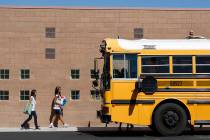 File - A school bus idles in the parking lot of the Mabel Hoggard Elementary School on Tuesday, ...