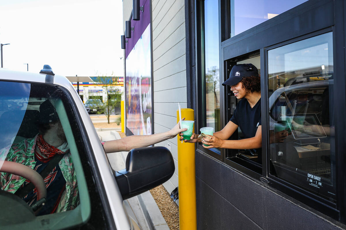 Employee Emmalise Reed hands off drinks to a customer at a new “Go Mobile” Taco B ...