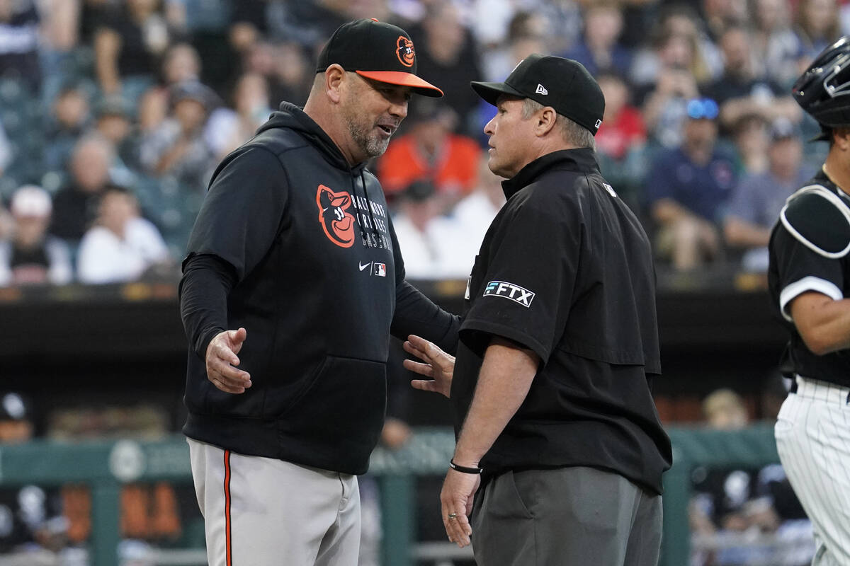 Baltimore Orioles manager Brandon Hyde, left, talks with umpire Marvin Hudson after the benches ...