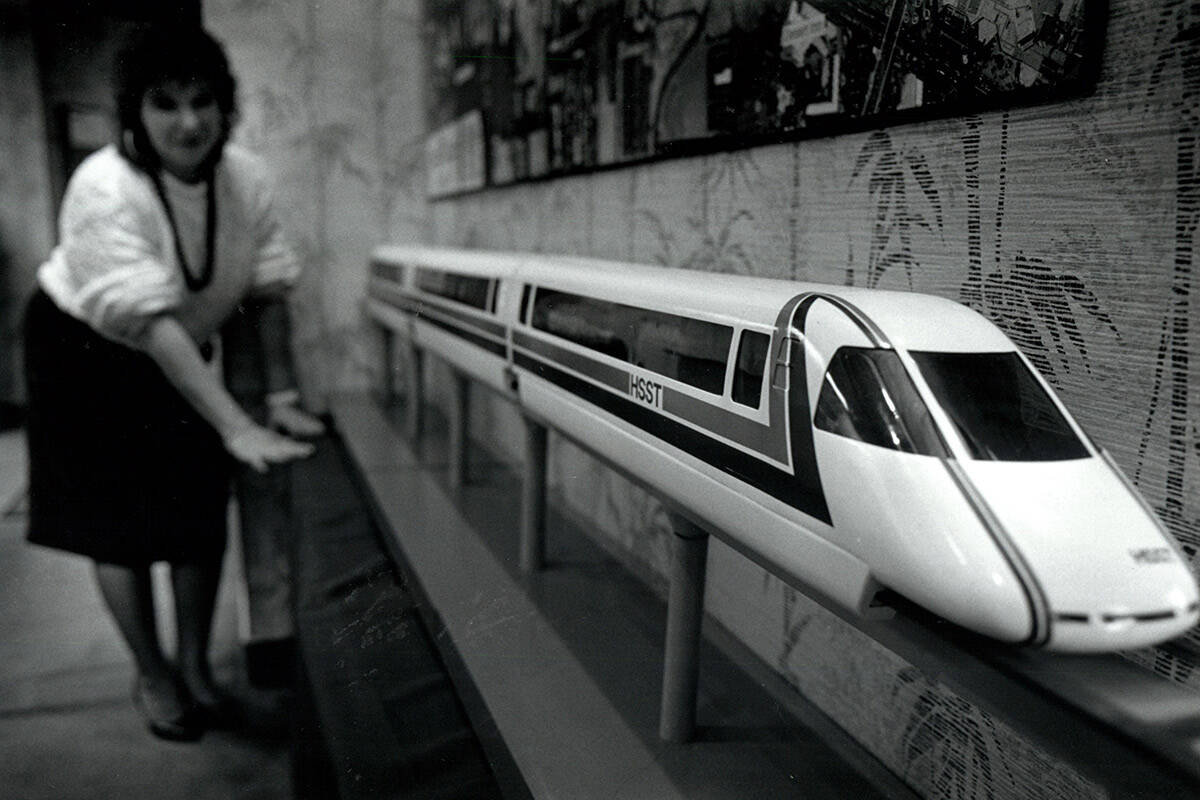 Denise Tedesco, office manager at High Speed Surface Transportation - Nevada, stands by a model ...