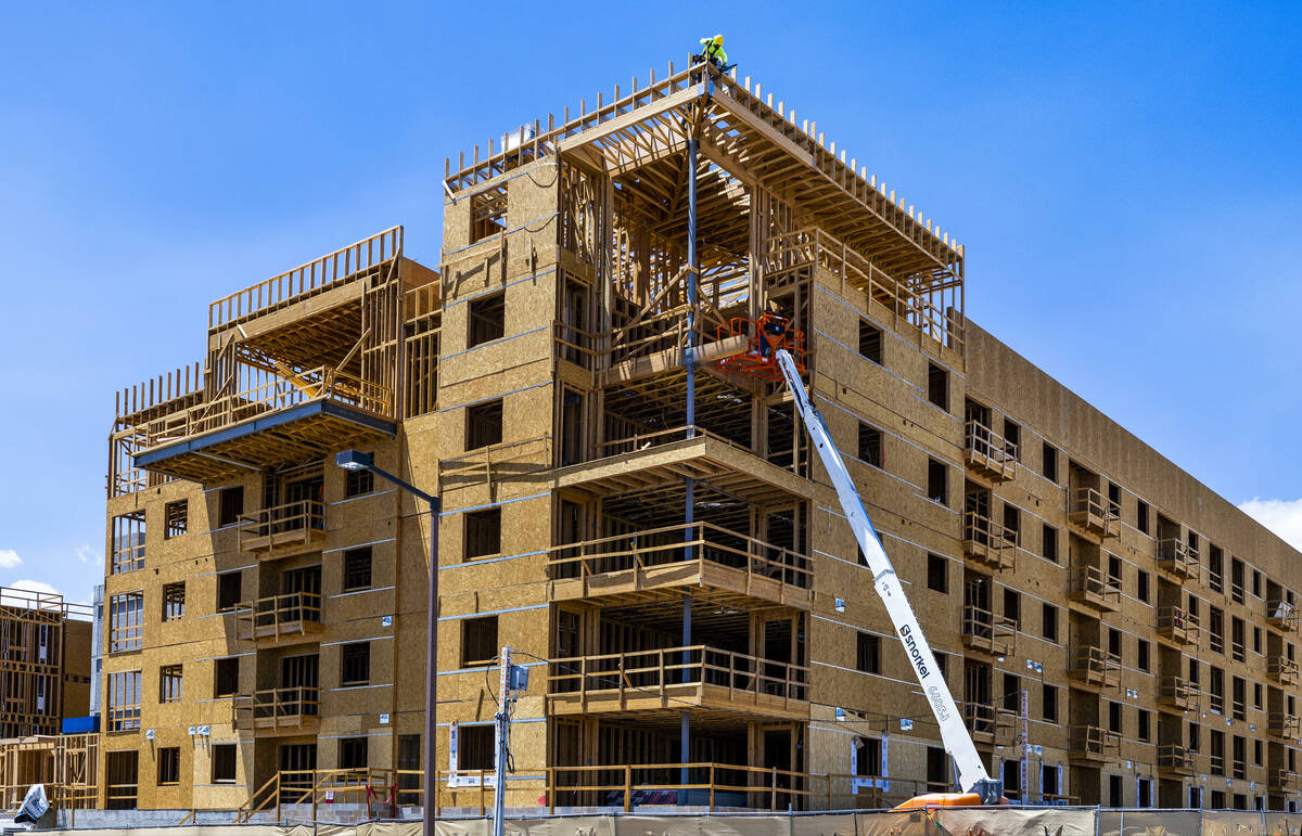 Construction continue on a new apartment building next to the existing Tanager apartment comple ...