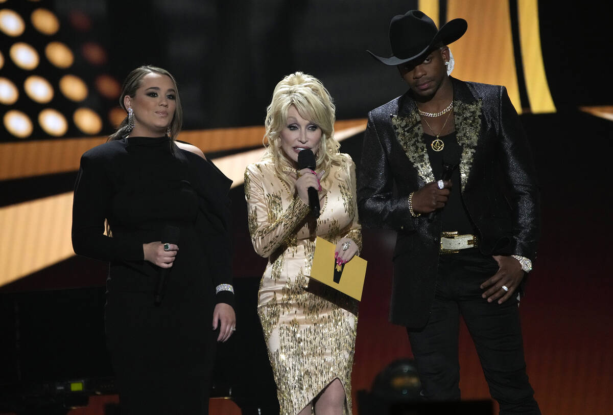 Gabby Barrett, from left, Dolly Parton, and Jimmie Allen speak at the 57th Academy of Country M ...