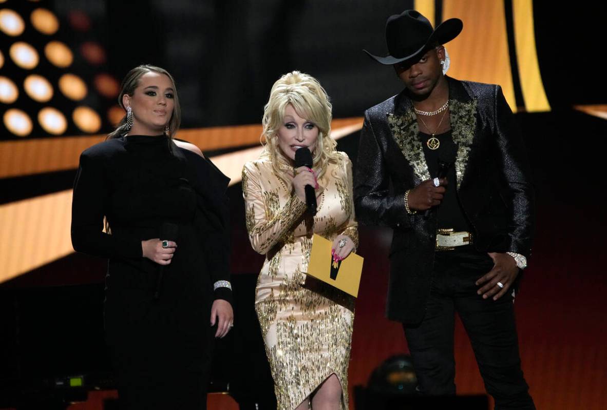 Gabby Barrett, from left, Dolly Parton, and Jimmie Allen speak at the 57th Academy of Country M ...