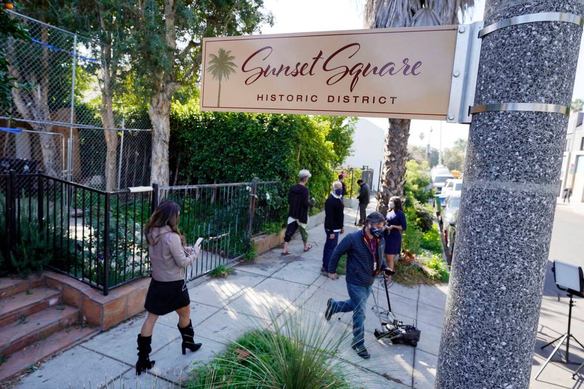 FILE - Members of the media and neighbors walk near an area on North Sierra Bonita Ave. where L ...