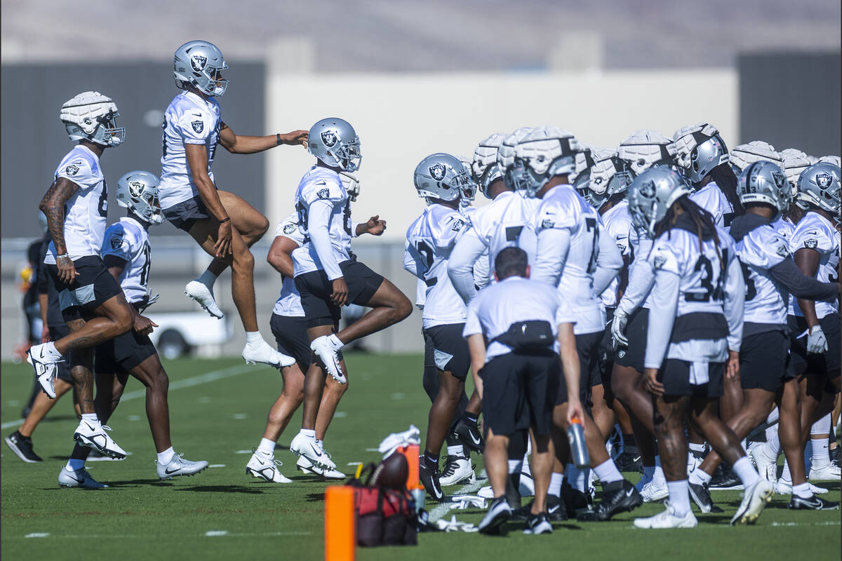 Tight end Darren Waller (83), left, and wide receiver Demarcus Robinson (11) jump as players ru ...