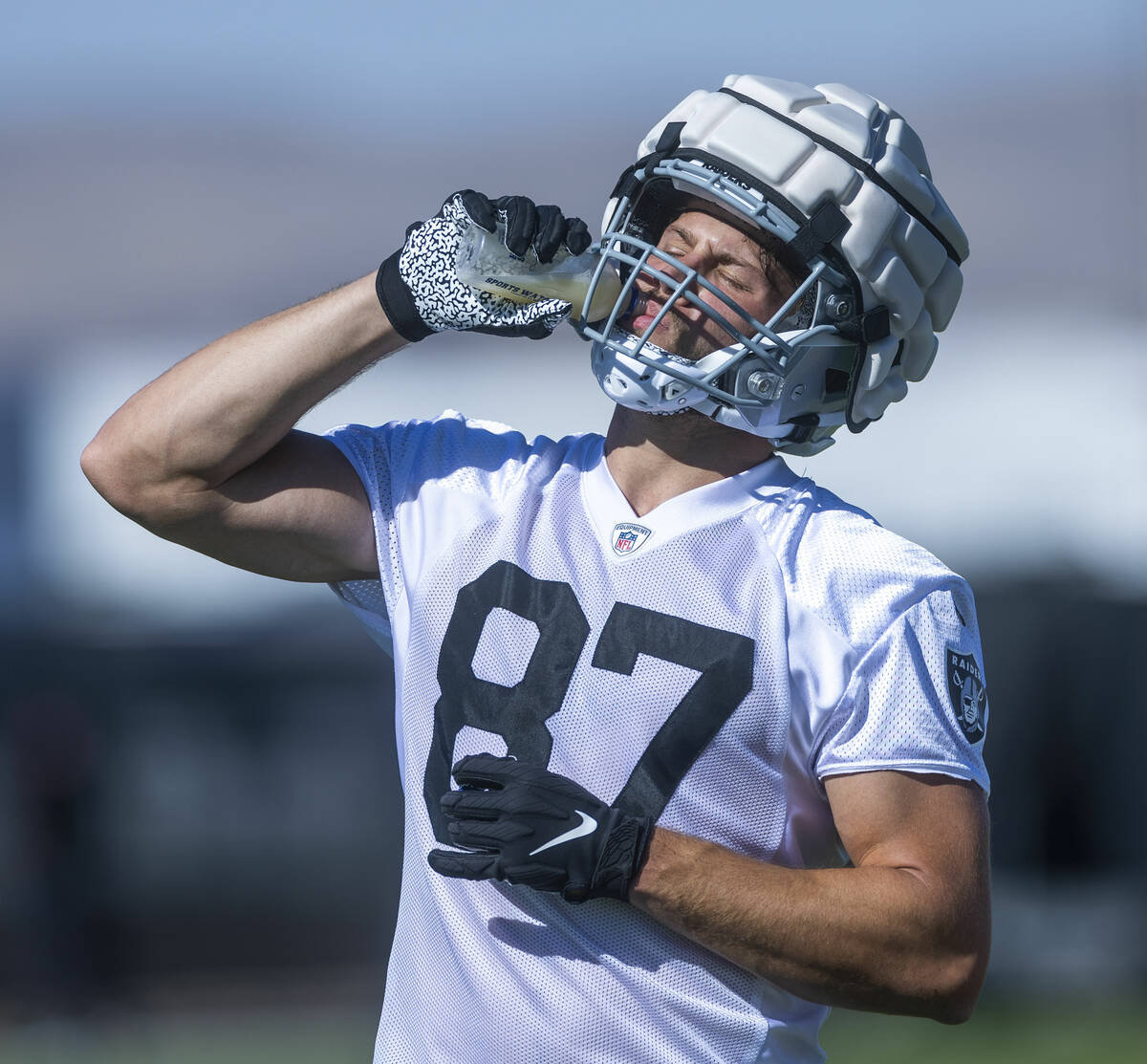 Tight end Foster Moreau (87) hydrates during the Raiders first practice at training camp in the ...