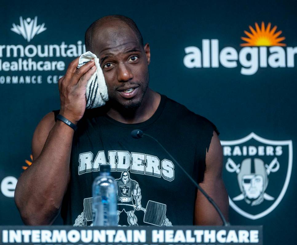 Safety Duron Harmon towels off in a press conference during the Raiders first practice at train ...