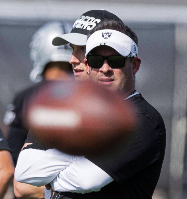 Raiders head coach Josh McDaniels watches his players during team's practice at training camp i ...