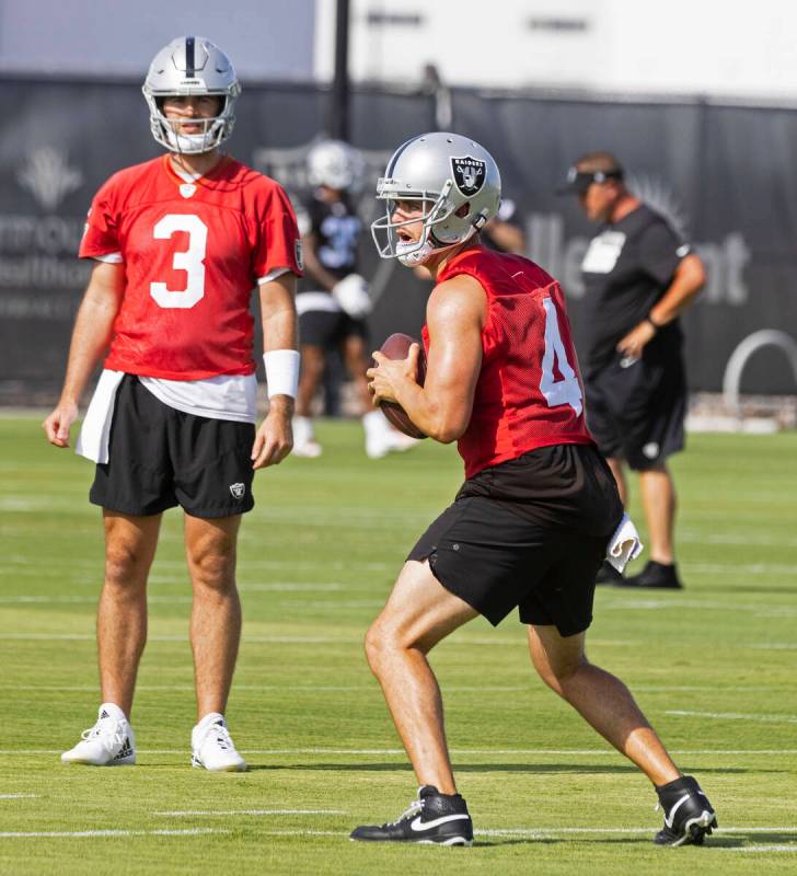 Raiders quarterback Derek Carr (4) prepares to throw the ball as back up quarterback Jarrett St ...