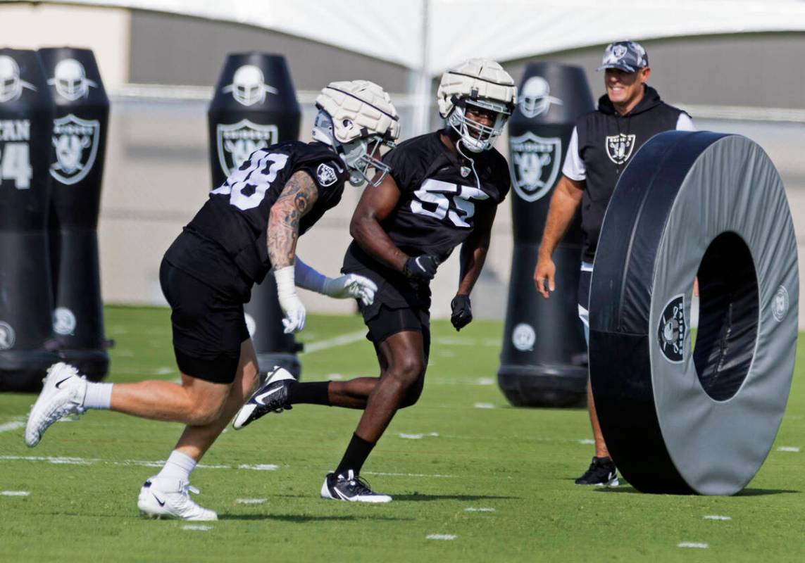 Raiders defensive ends Maxi Crosby (98) and Chandler Jones (55) run the drill during team's pra ...