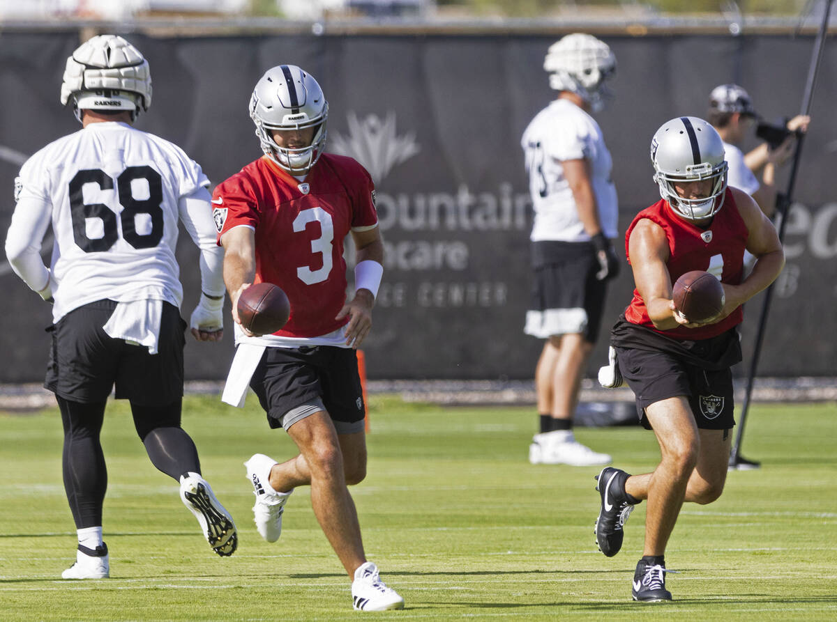 Raiders quarterback Derek Carr (4) and back up quarterback Jarrett Stidham (3) run through quar ...