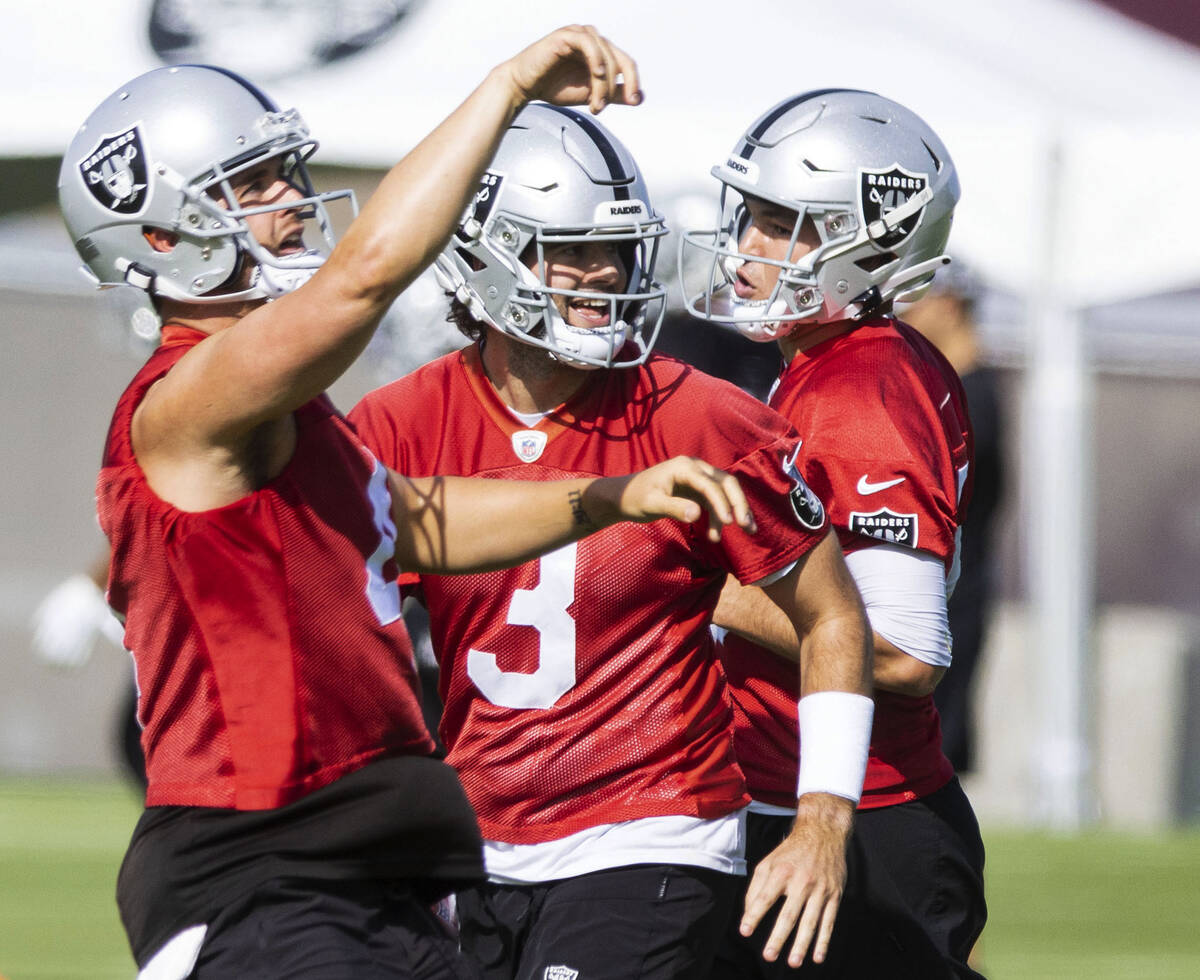 Raiders quarterback Derek Carr (4) and back up quarterbacks Jarrett Stidham (3) and Nick Mullen ...