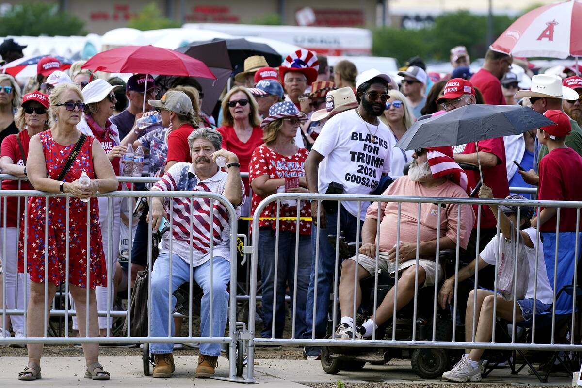 Supporters of former President Donald Trump wait in line hours before the former president is s ...