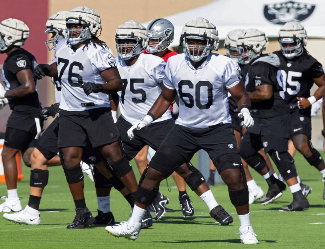 Raiders offensive guard John Simpson (76), offensive tackle Brandon Parker (75) and offensive t ...