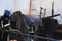 In this photo provided by the Odesa City Hall Press Office, firefighters put out a fire in a po ...