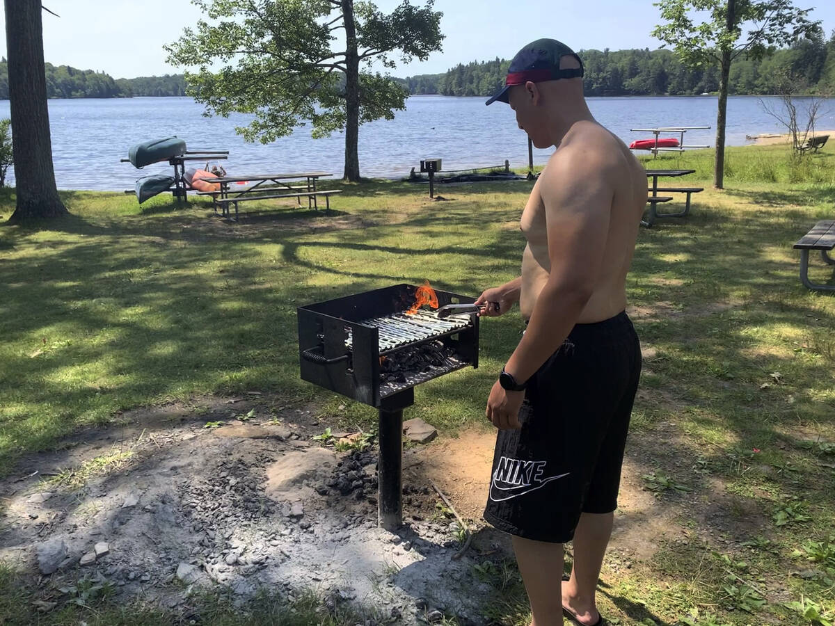 Mhamed Moussa Boudjelthia, of New York City, works a grill Sunday, July 24, 2022 at Promised La ...