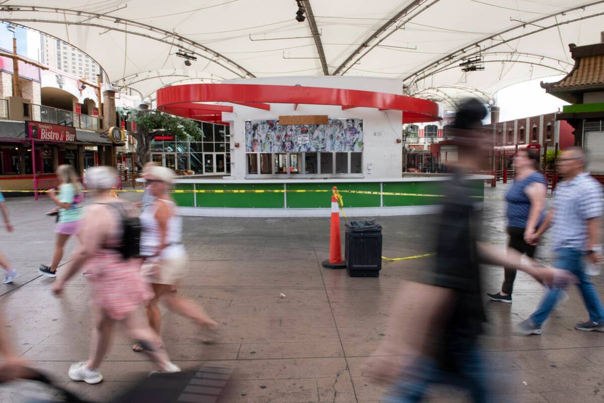 Pedestrians walk through the closed Hawaiian Marketplace on Las Vegas Boulevard on Monday, July ...