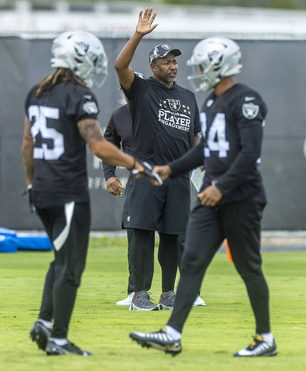 Raiders defensive coordinator Patrick Graham talks to players as safety Tre'von Moehrig (25) an ...