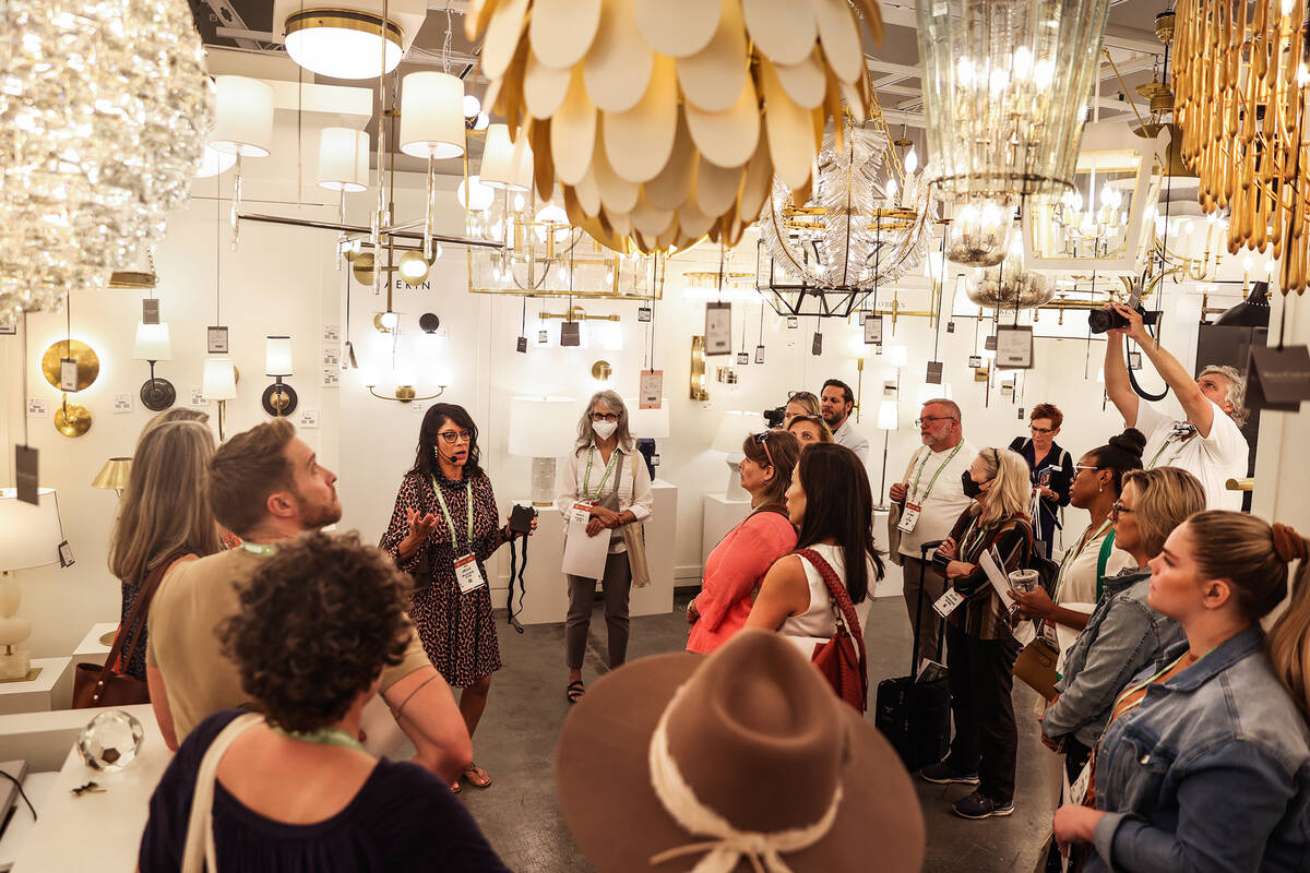 Linda Allen, of Linda Allen Designs, leads a tour about lighting at the Summer Market, a furnit ...