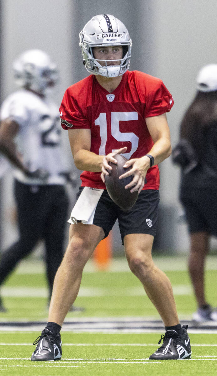 Raiders quarterback Chase Garbers (15) looks to throw a pass during the team’s training ...