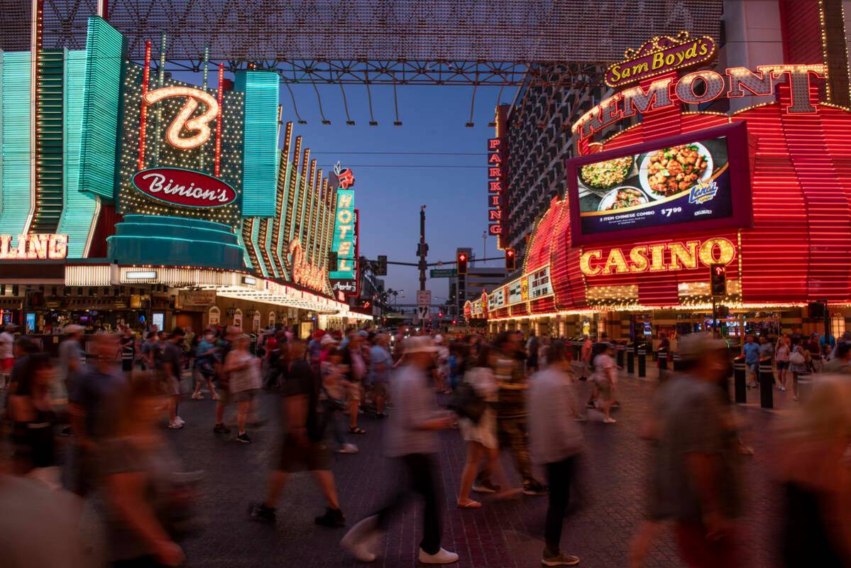 In this June 19, 2022, file photo, people walk around the Fremont Street Experience in downtown ...