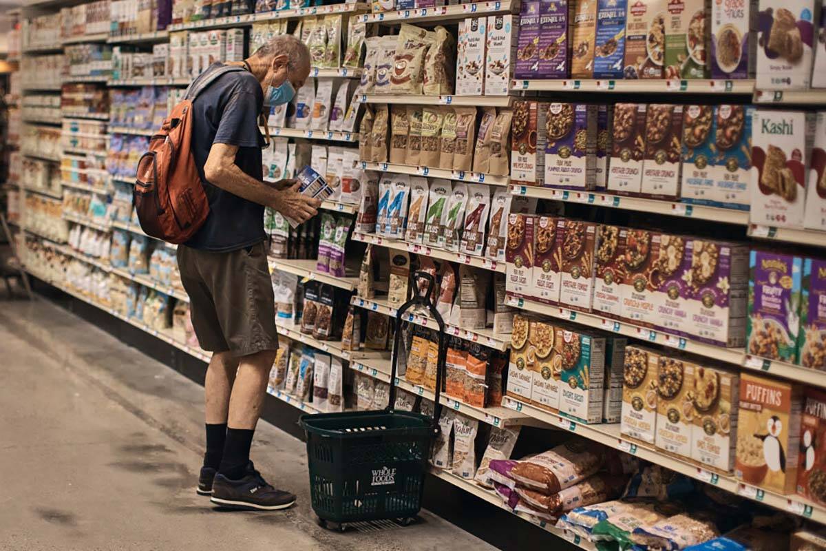 A man shops at a supermarket on Wednesday, July 27, 2022, in New York. The Federal Reserve on W ...