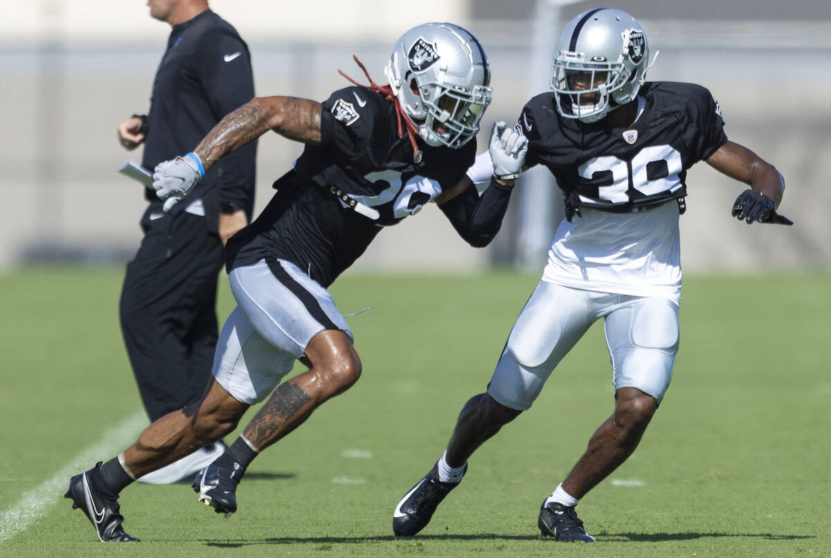 Raiders cornerback Anthony Averett (29) works against cornerback Nate Hobbs (39) during the tea ...