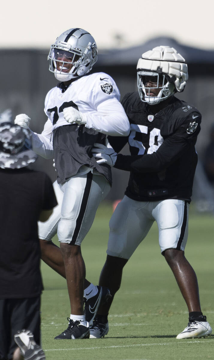 Raiders running back Kenyan Drake (23) is stopped by linebacker Darien Butler (58) during the t ...