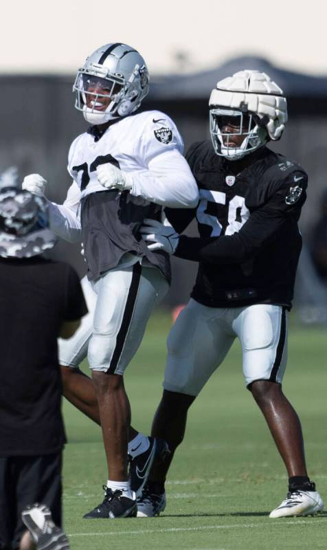 Raiders running back Kenyan Drake (23) is stopped by linebacker Darien Butler (58) during the t ...