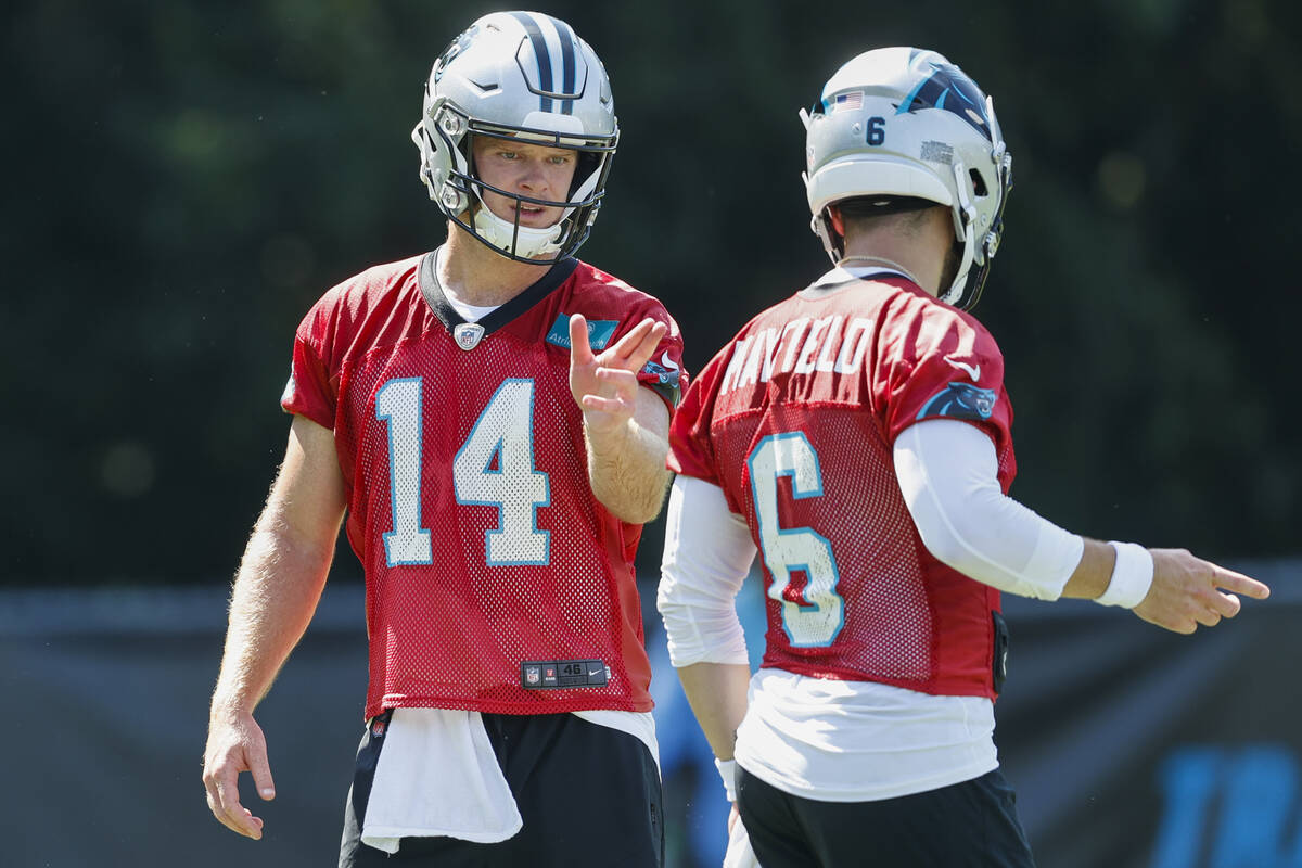 Carolina Panthers quarterback Sam Darnold (14) talks with quarterback Baker Mayfield (6) during ...