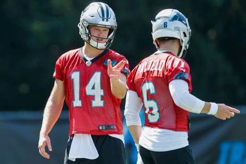 Carolina Panthers quarterback Sam Darnold (14) talks with quarterback Baker Mayfield (6) during ...