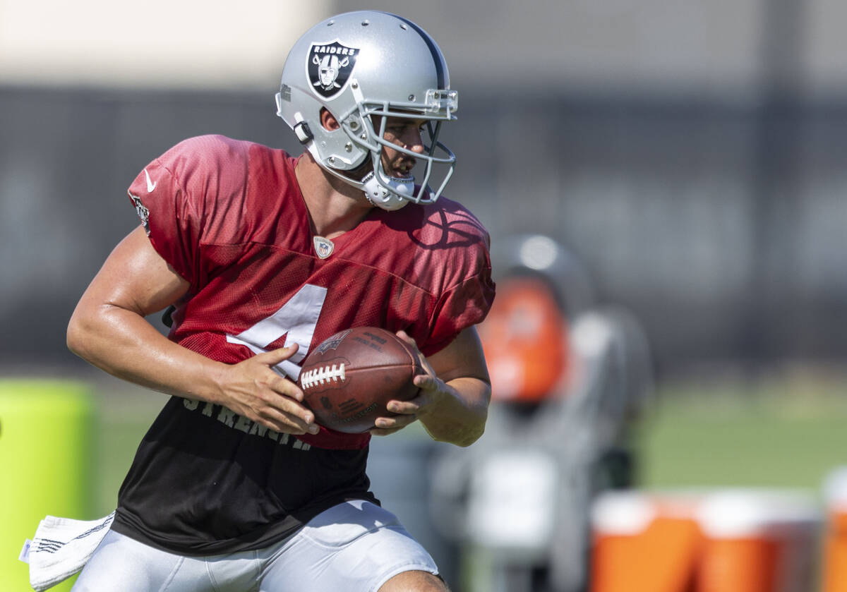 Raiders quarterback Derek Carr (4) looks to hand off the football during the team’s trai ...