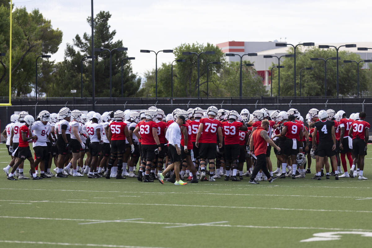 UNLV players huddle during a team football practice at UNLV in Las Vegas, Saturday, July 30, 20 ...