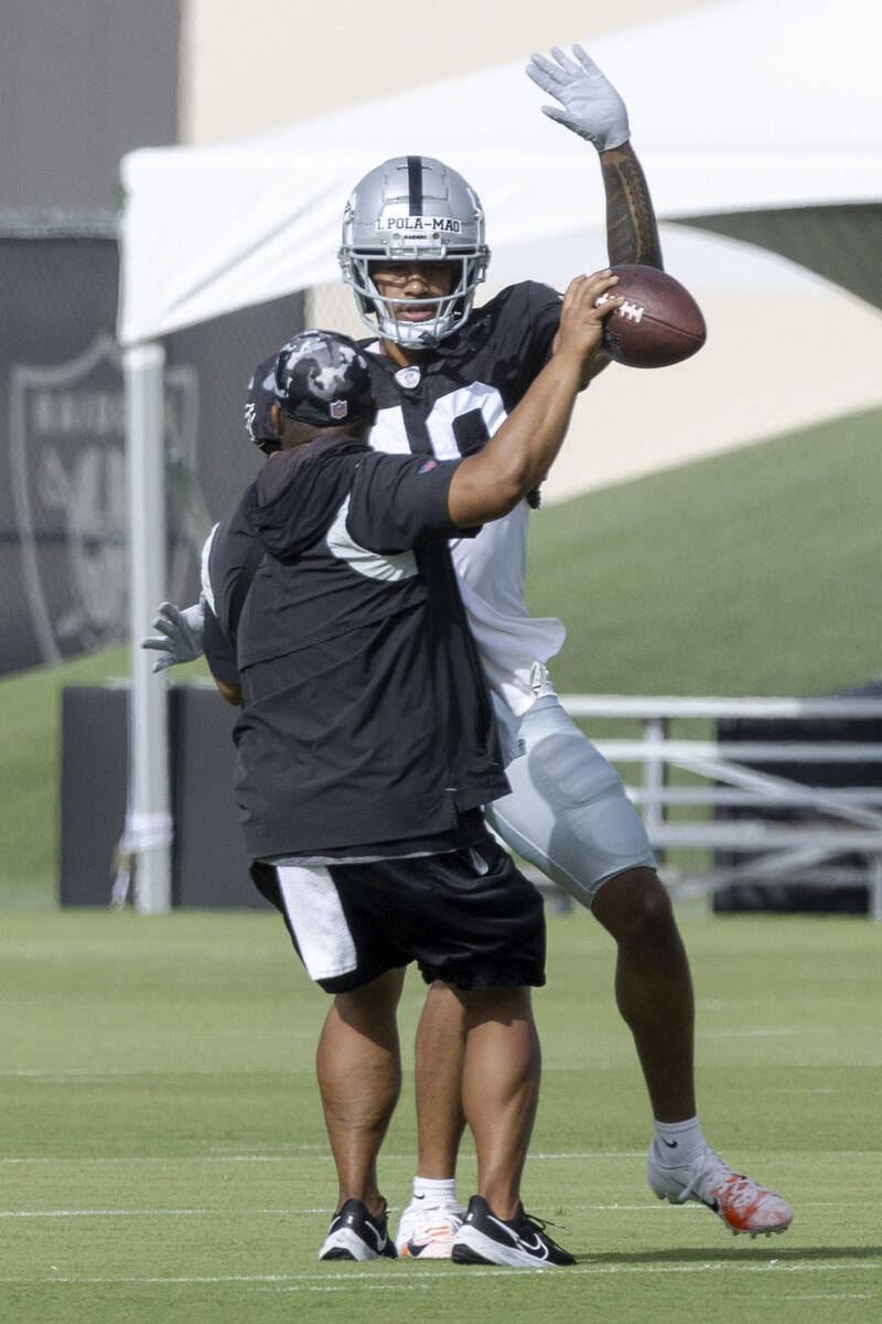 Raiders safety Isaiah Pola'mau (40) tries to force a turnover during the team’s training ...
