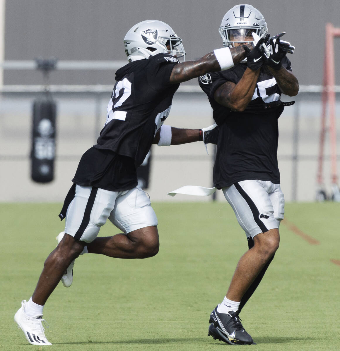Raiders safety Qwynnterrio Cole (42) works with safety Tre'von Moehrig (25) during a drill at t ...